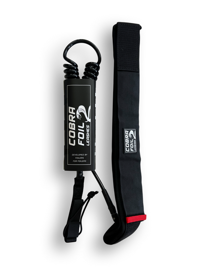 A black Cobra Foil leash with a double coil cord and a neoprene padded waist belt.